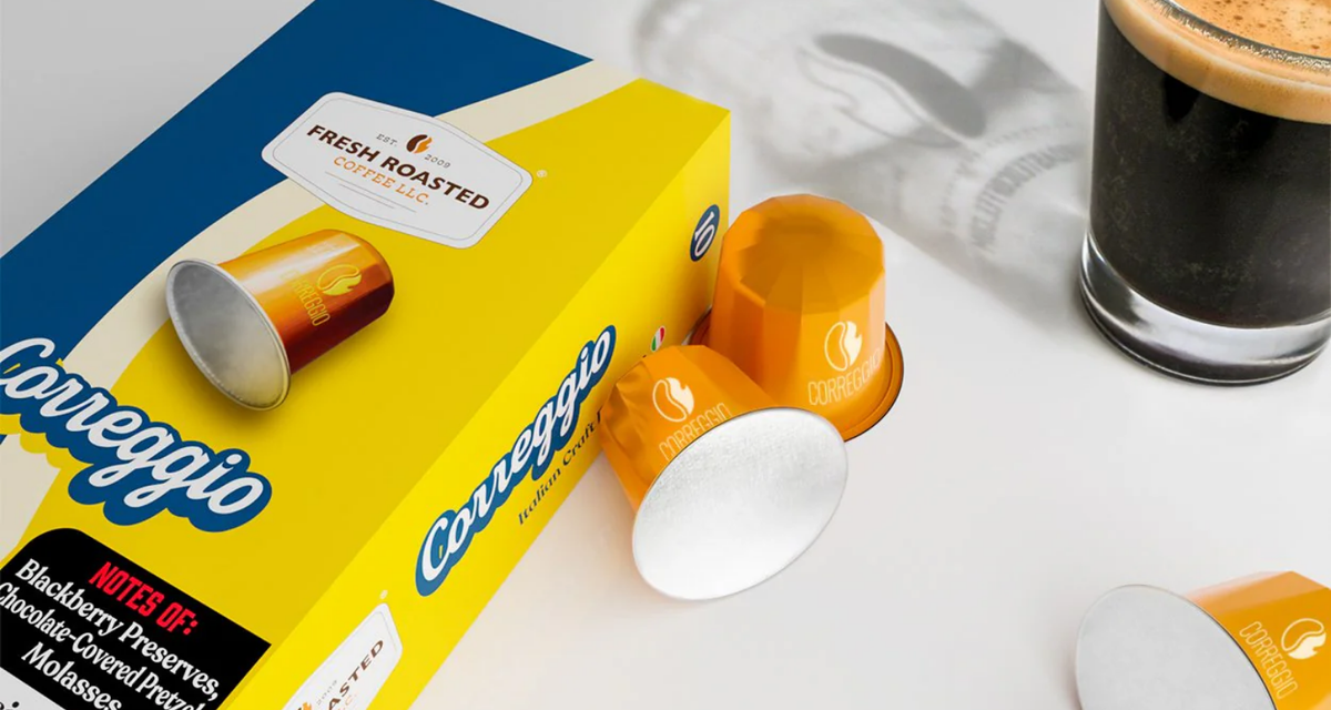 The Correggio Espresso Capsule box with orange capsules next to it. 
